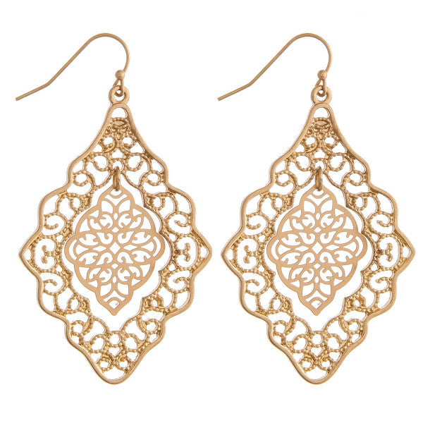 GOLD Long metal earrings featuring a filigree inspired hanging center accent