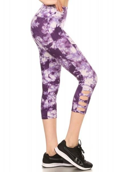 Tie dye print, cropped, high waisted workout leggings in fitted style with an elastic waistband and leg cutouts