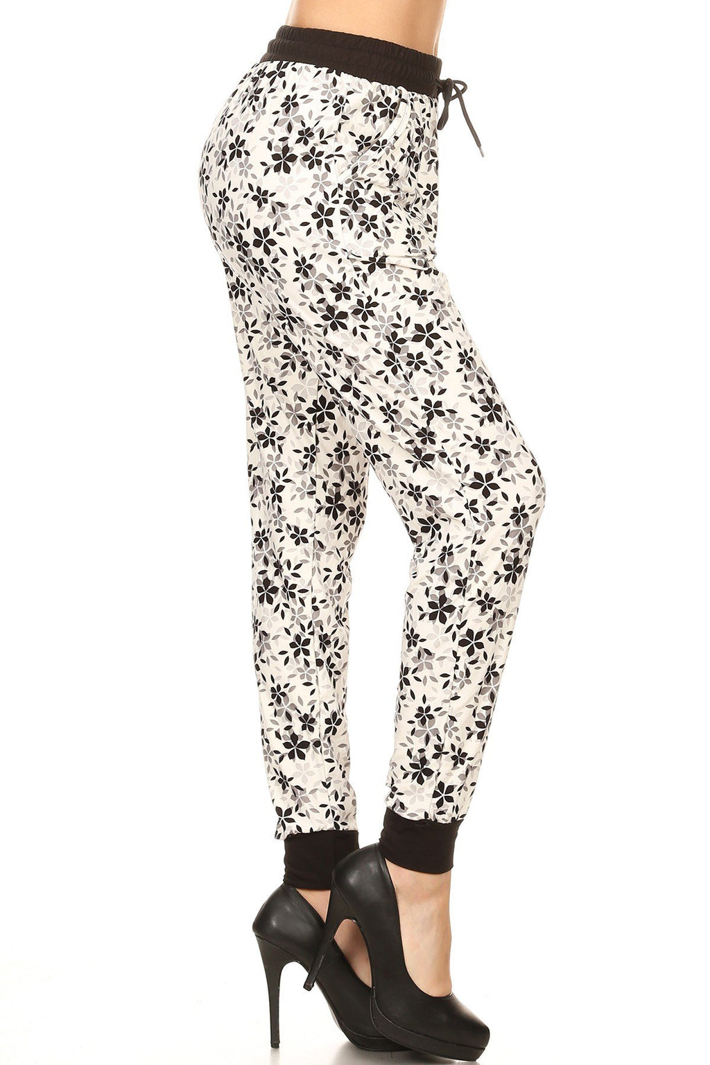 B/W MIXED FLORAL joggers with solid trim, drawstring waistband, waist pockets, and cuffed hems