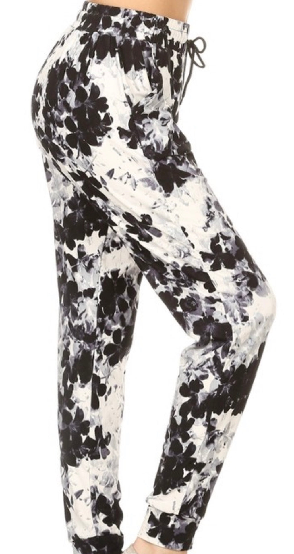 B/W FLORAL joggers with solid trim, drawstring waistband, waist pockets, and cuffed hems