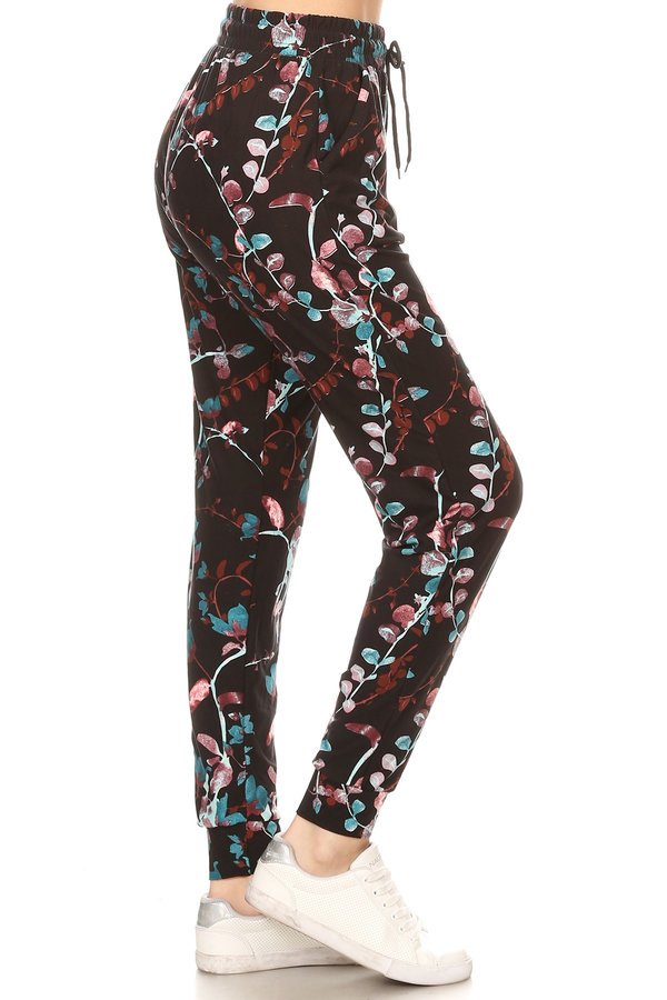 PASTEL FLORAL printed joggers with solid trim, drawstring waistband, waist pockets, and cuffed hems