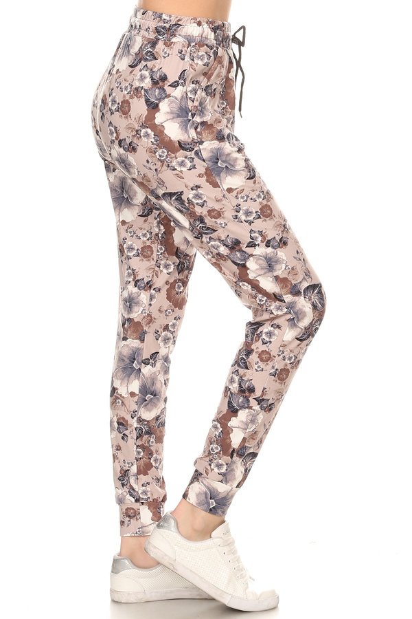 Floral printed joggers with solid trim accent, elastic waist with drawstring, waist pockets and cuffed hem