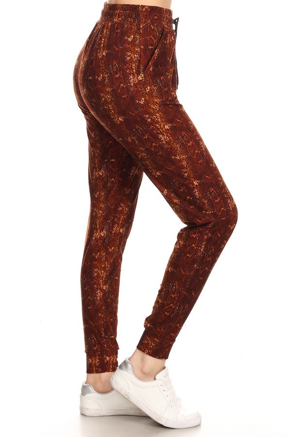 Snakeskin printed joggers with solid trim, drawstring waistband, waist pockets, and cuffed hems